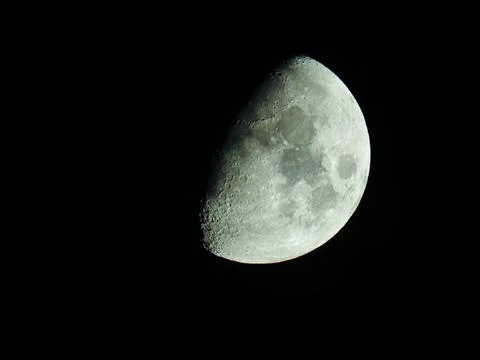 A close-up of the crescent moon with its moon craters Foto stock