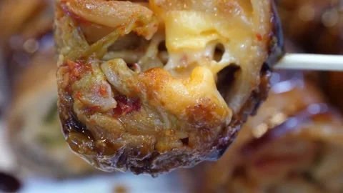 Close-up of Crispy Bacon Wrapped Onion Ring Stuffed with Melted Cheddar Cheese o Video stock 343588181