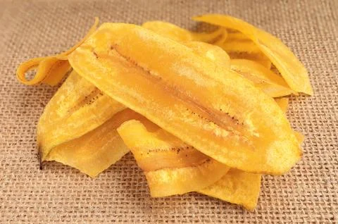 Close up of crispy banana slice chips, fried or baked slice banana. Stock Photos