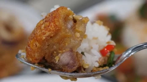 Close-up of Crispy Deep Fried Pork Belly with Steamed Rice and Chili on a Spoon Stock Footage 338212021