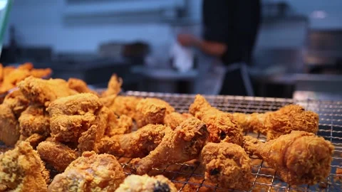 Close up of crispy fried chicken on a metal wire rack at a food court display. Stock Footage 331517146