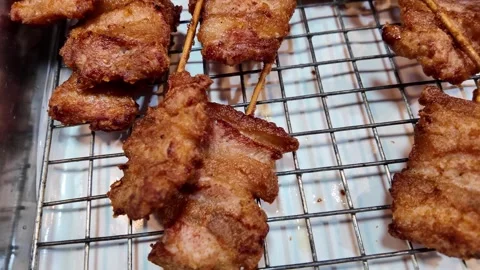 Close Up of Crispy Fried Meat Skewers on Wire Rack Stock-Footage 343763956