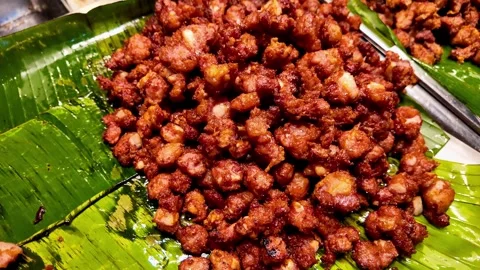 Close Up of Crispy Fried Pork Pieces on Banana Leaf Stock Footage 343763773