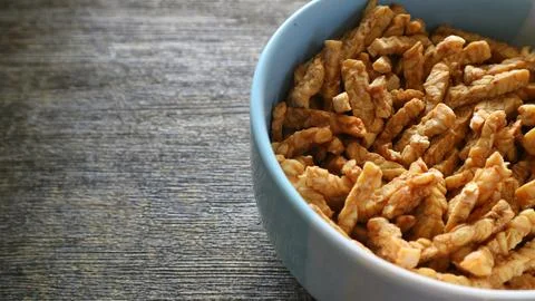Close up of crispy fried sliced tempeh in a ceramic bowl Stock Photos