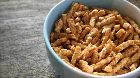 Close up of crispy fried sliced tempeh in a ceramic bowl Stock Photos