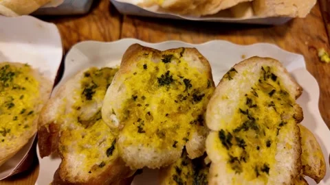 Close Up of Crispy Garlic Bread with Herb Butter Served on Plate Video stock 337227287