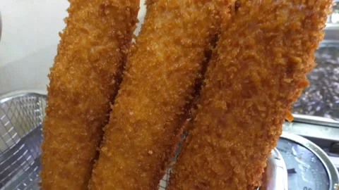 Close-up of Crispy Golden Korean Corn Dogs Fried at a Street Food Stall Video stock 343587671