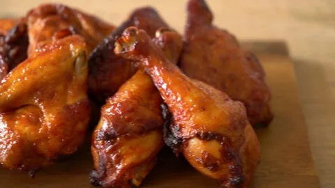 Close-Up of Crispy Grilled Chicken Wings on Wooden Surface Stock Footage 288372993