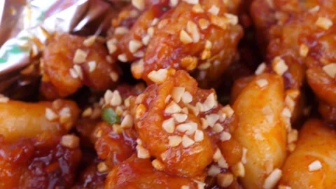 Close Up of Crispy Korean Fried Chicken Glazed in Spicy Sweet Sauce with Crushed Video stock 343028034
