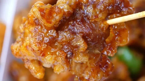 Close Up of Crispy Sweet and Spicy Korean Fried Chicken (Dakgangjeong) Picked Up Video stock 343027528
