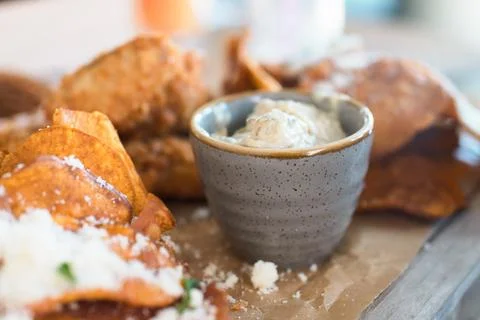 A close-up of crispy sweet potato chips topped with parmesan cheese and par.. Stock Photos
