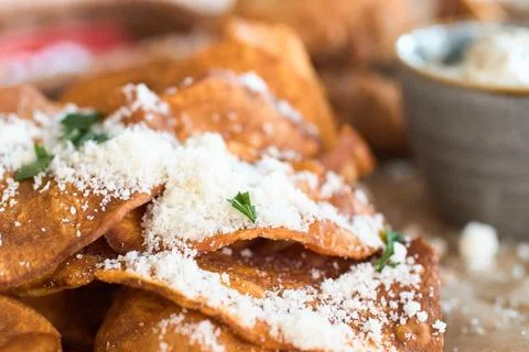 Close-up of crispy sweet potato chips topped with grated parmesan cheese an.. Stock Photos