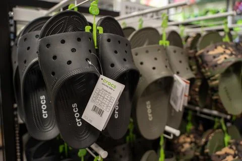 Close up of Crocs slide sandals displayed in store. Toronto, Canada - July 13, Stock Photos