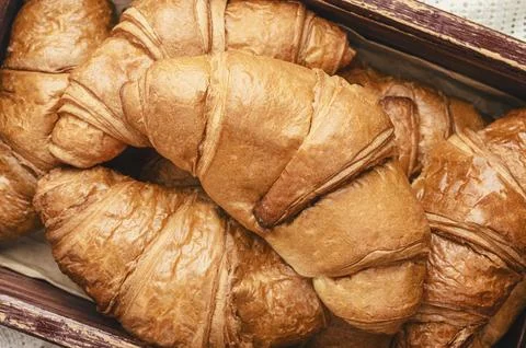 Close-up of croissants on a dark background. Fresh and delicious French pas.. Stock Photos
