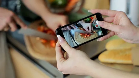 Close crop Happy couple Taking video using smartphone of chopping healthy salad Stock Footage 73752796