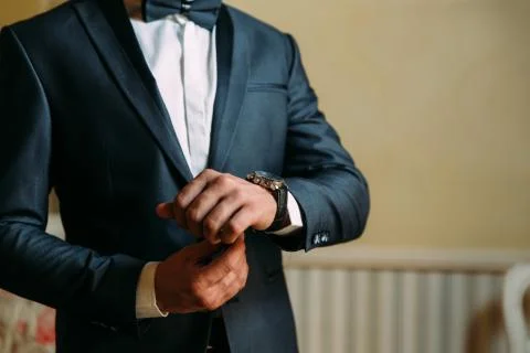 A close-up of a cropped frame of a man in an expensive classic costume looks at Stock Photos