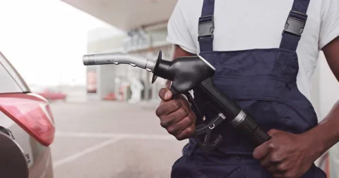 Close up cropped image of black skinned man in workwear, gas station worker Stock Footage 152649362