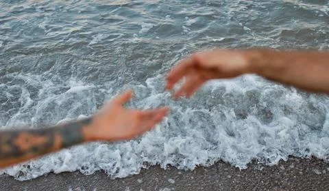 Close-up cropped image of the hands of a young couple against the backdrop of Stock Photos