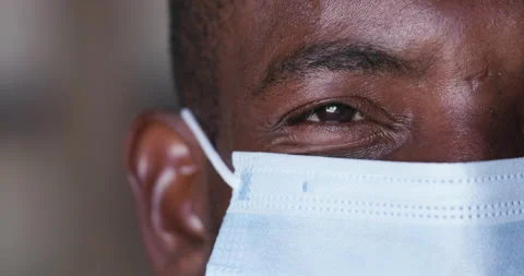 Close-up cropped portrait view of a Black African man wearing face mask Covid-19 Stock Footage 133923337