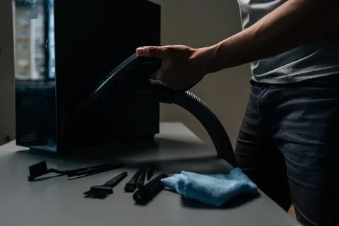 Close-up cropped shot of computer technician cleaning computer case with vacuum Stock Photos