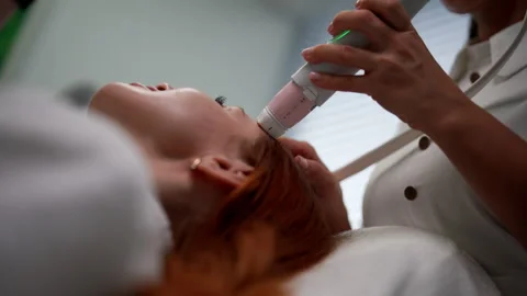 Close-up cropped shot of physician using modern device performing mesotherapy Stock Footage 311493274