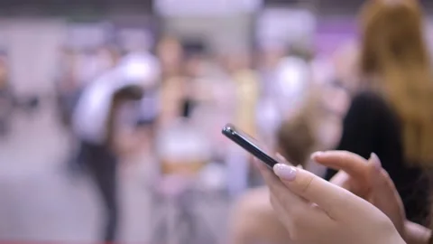 Close-up cropped shot of pretty smiling young woman using typing mobile phone Stock Footage 249953744