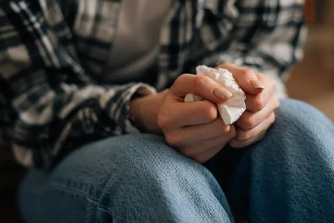 Close-up cropped shot of unrecognizable crying young woman holding paper tissues Stock Photos
