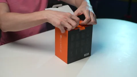 Close-up cropped shot of unrecognizable man unpacking box with new PC CPU air Stock Footage 233993965