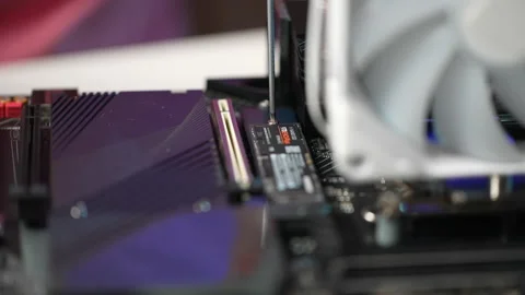 Close-up cropped shot of unrecognizable man screwing in bolts fixing new NVMe M Stock Footage 234325316