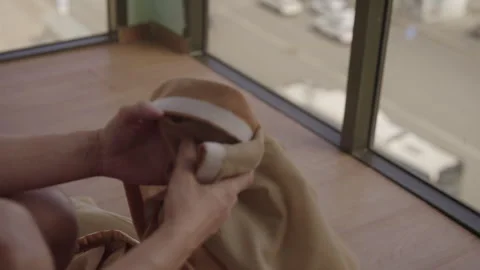 Close-up cropped shot of unrecognizable man changing dusty curtains, sitting by Stock Footage 313716629