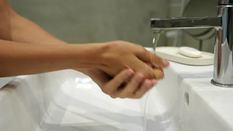 Close-up cropped shot of unrecognizable young woman washing hands with soap and Stock Footage 220721653