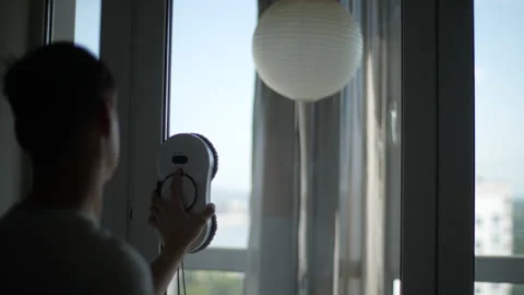 Close-up cropped shot of unrecognizable young man putting rag on robotic window Stockbeeldmateriaal 251046161