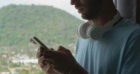 Close-up. Cropped view of a relaxed Caucasian guy typing text message on Stock Footage 219950330