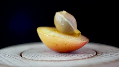 Close-up. Cross section of a yellow cherry. Bone and inside of cherry Stock Footage 202604662