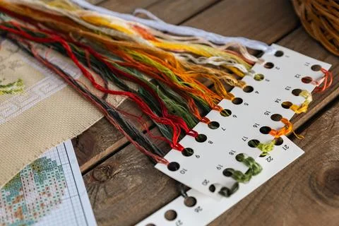 Close-up of a cross-stitch in progress. Cross-stitch with various colorful th Stock Photos