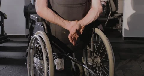 Close-up of crossed arms behind the back against the background of a wheelchair. Vídeo Stock 146680978