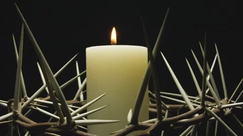 Close-up of the crown of thorns with a white burning candle. Circular filming. Stock-Footage 303954851