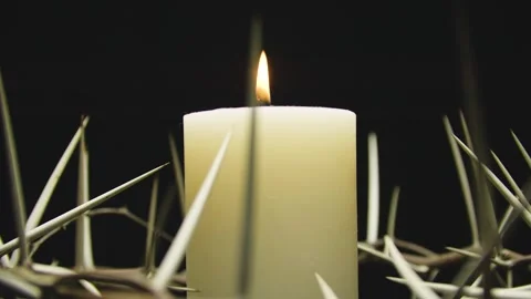 Close-up of the crown of thorns with a white burning candle. Circular filming. Stock-Footage 303955000