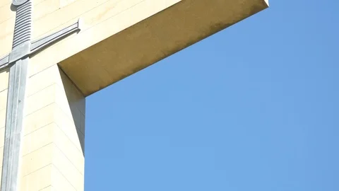 Close up of crucifix against bright blue sky, negative space Stock Footage 102878374