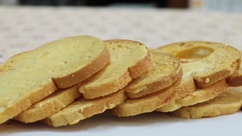 Close up of crunchy baked bread rusks stacked on a table. 스톡 동영상 339991104