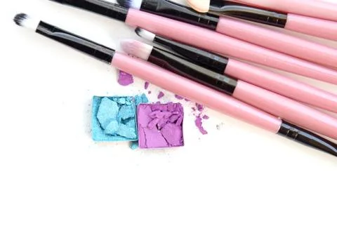 Close up of crushed blush on white background and cosmetic brush Stock Photos