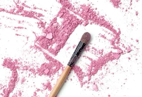 Close up of crushed blush on white background and cosmetic brush Stock Photos