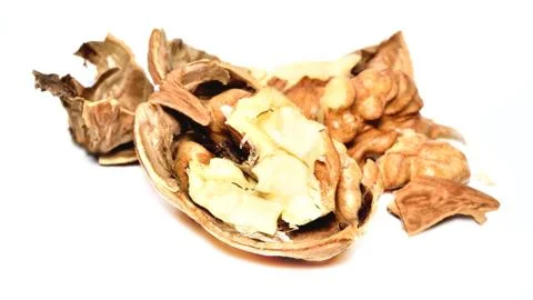 Close-up of crushed walnuts with nutshell isolated on white background Stock Photos