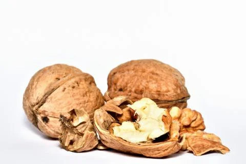 Close-up of crushed walnuts with nutshell isolated on white background Stock Photos