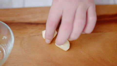 Close-up of crushing large cloves of garlic with a garlic press in 4K. Stock Footage 138056439