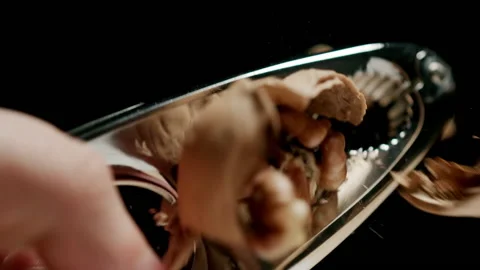 CLOSE UP: Crushing a walnut with a steel nutcracker. Slow motion. Stock Footage 144415951
