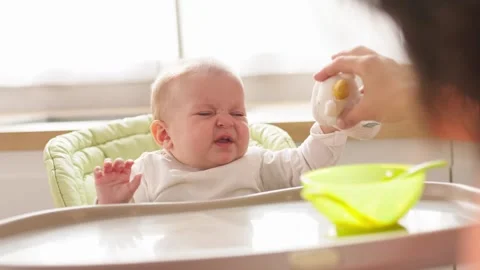 Close up cry newborn don t want to eat young father trying feeding baby. Show Stock Footage 302661198