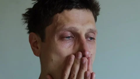 Close up of Crying man with tears in eye. Tear rolling down a mans cheek. A male Stock Footage 312098696