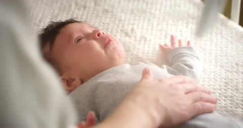 Close up of a crying newborn baby lying on its back in a child crib. Stock Footage 167285082