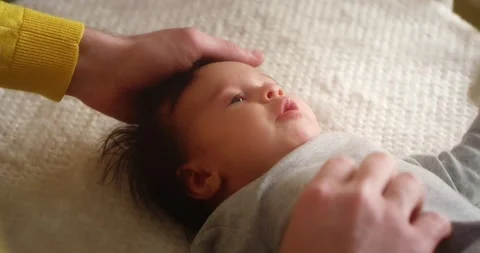 Close up of a crying newborn baby lying on its back in a child crib. Stock Footage 167285520